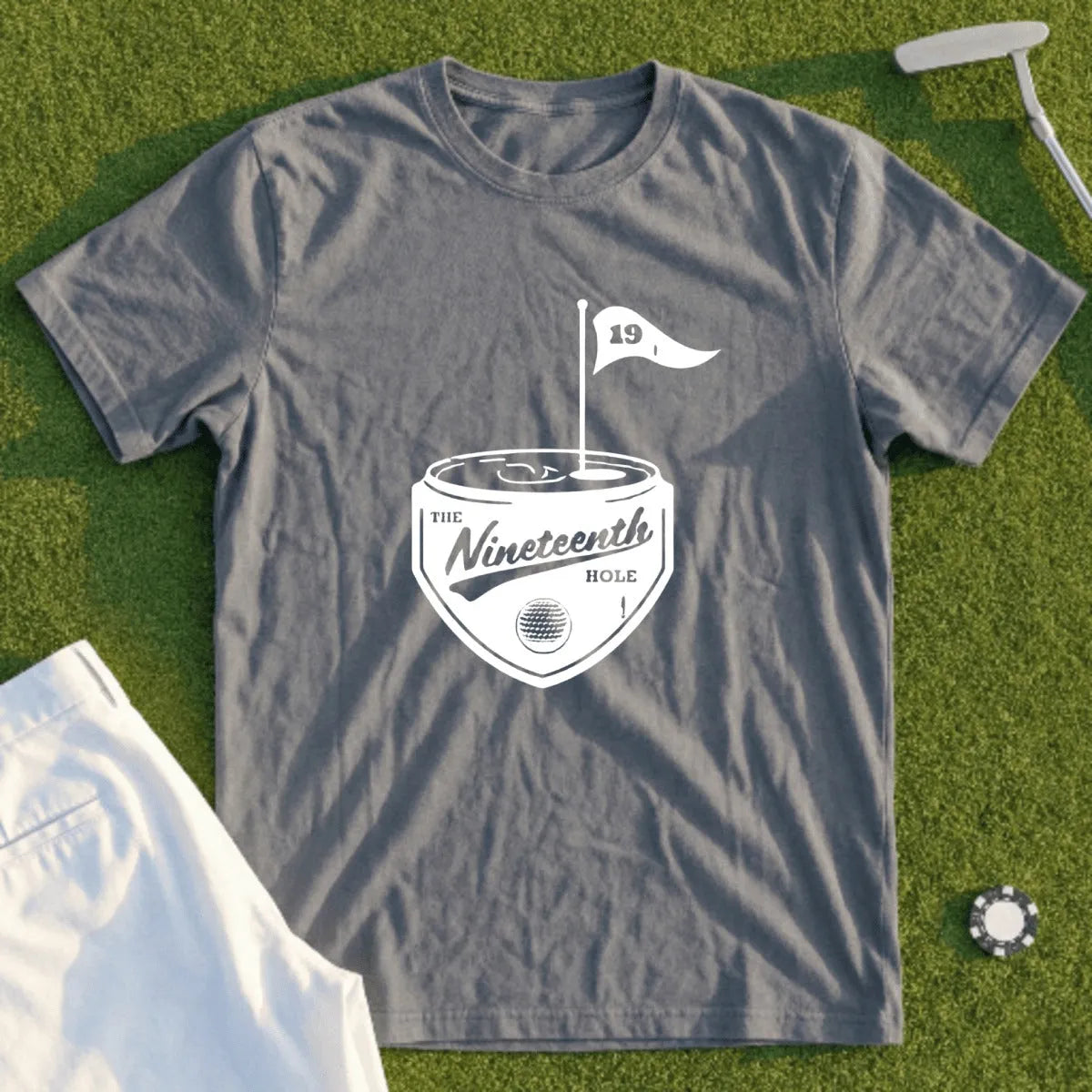 Gray t-shirt with "The Nineteenth Hole" golf-themed graphic and flag.