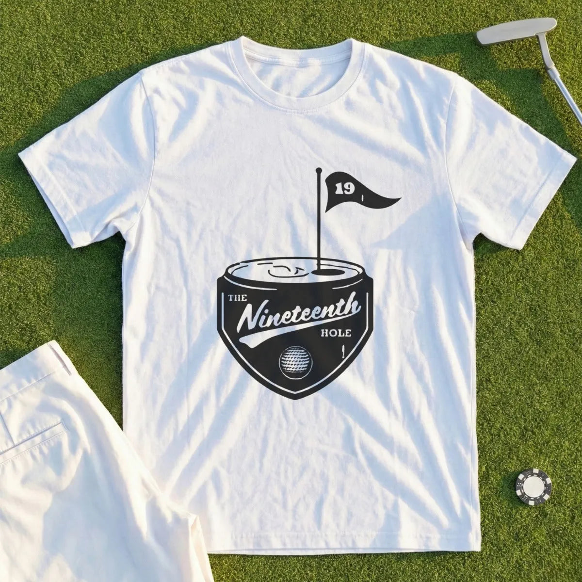 White t-shirt with "The Nineteenth Hole" shield logo and golf flag.
