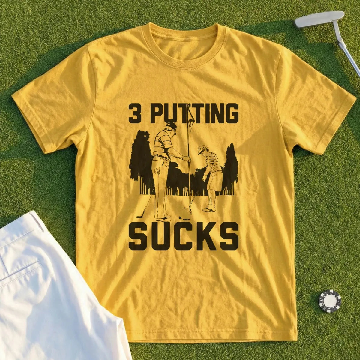 Yellow t-shirt with "3 PUTTING SUCKS" graphic and two golfers.