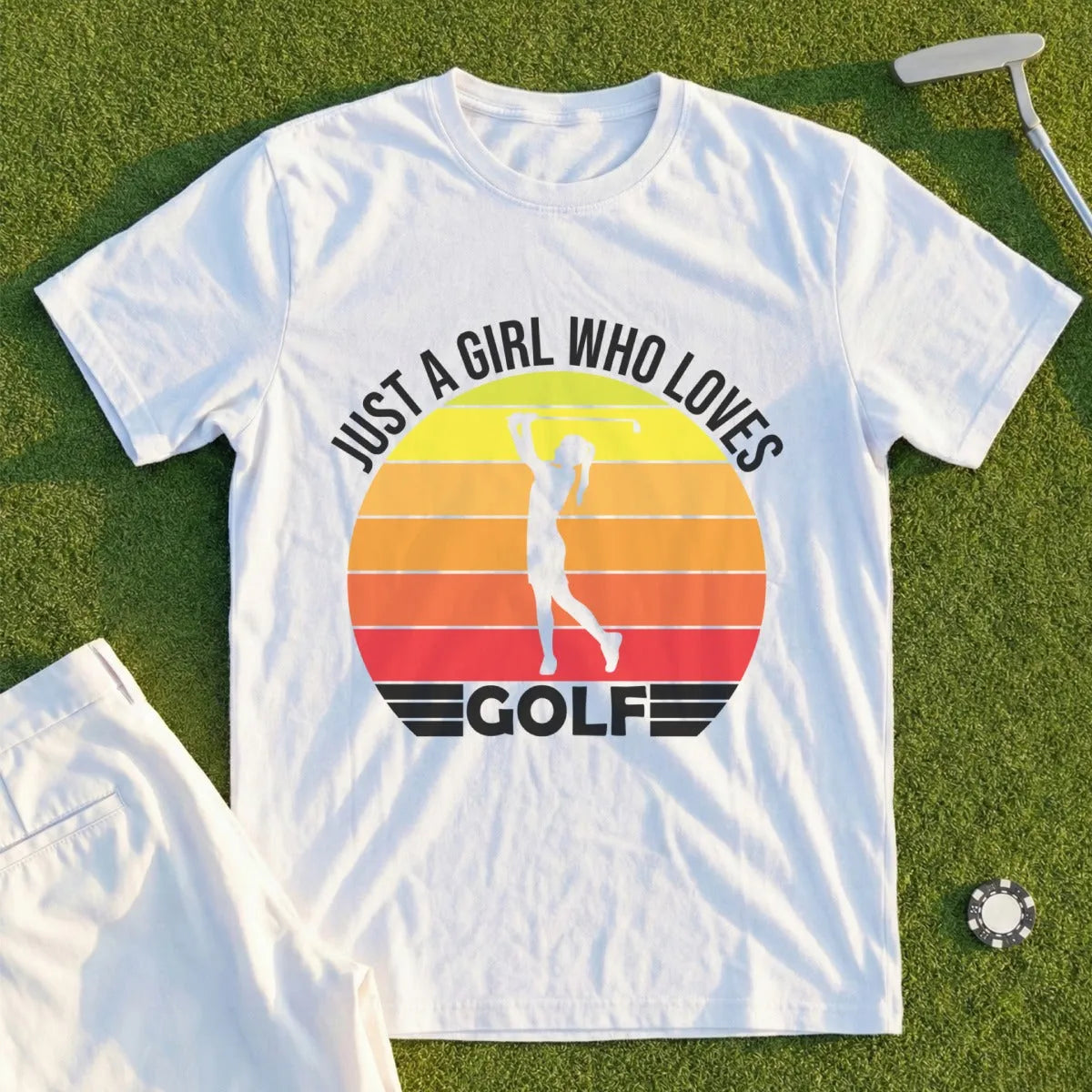 White t-shirt with a graphic of a golfer and "JUST A GIRL WHO LOVES GOLF" text.