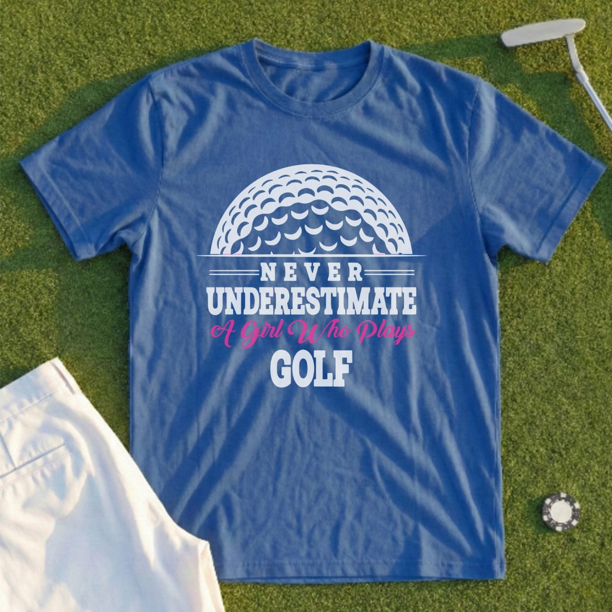 Blue t-shirt with "Never Underestimate A Girl Who Plays Golf" text and golf ball design.
