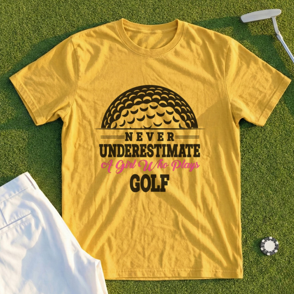 Yellow t-shirt with "Never Underestimate A Girl Who Plays Golf" text and golf ball graphic.