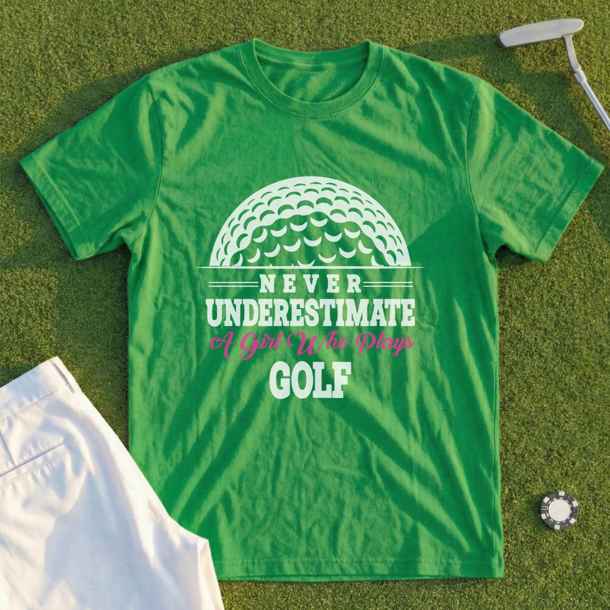 Green t-shirt with "Never Underestimate A Girl Who Plays Golf" text and golf ball graphic.