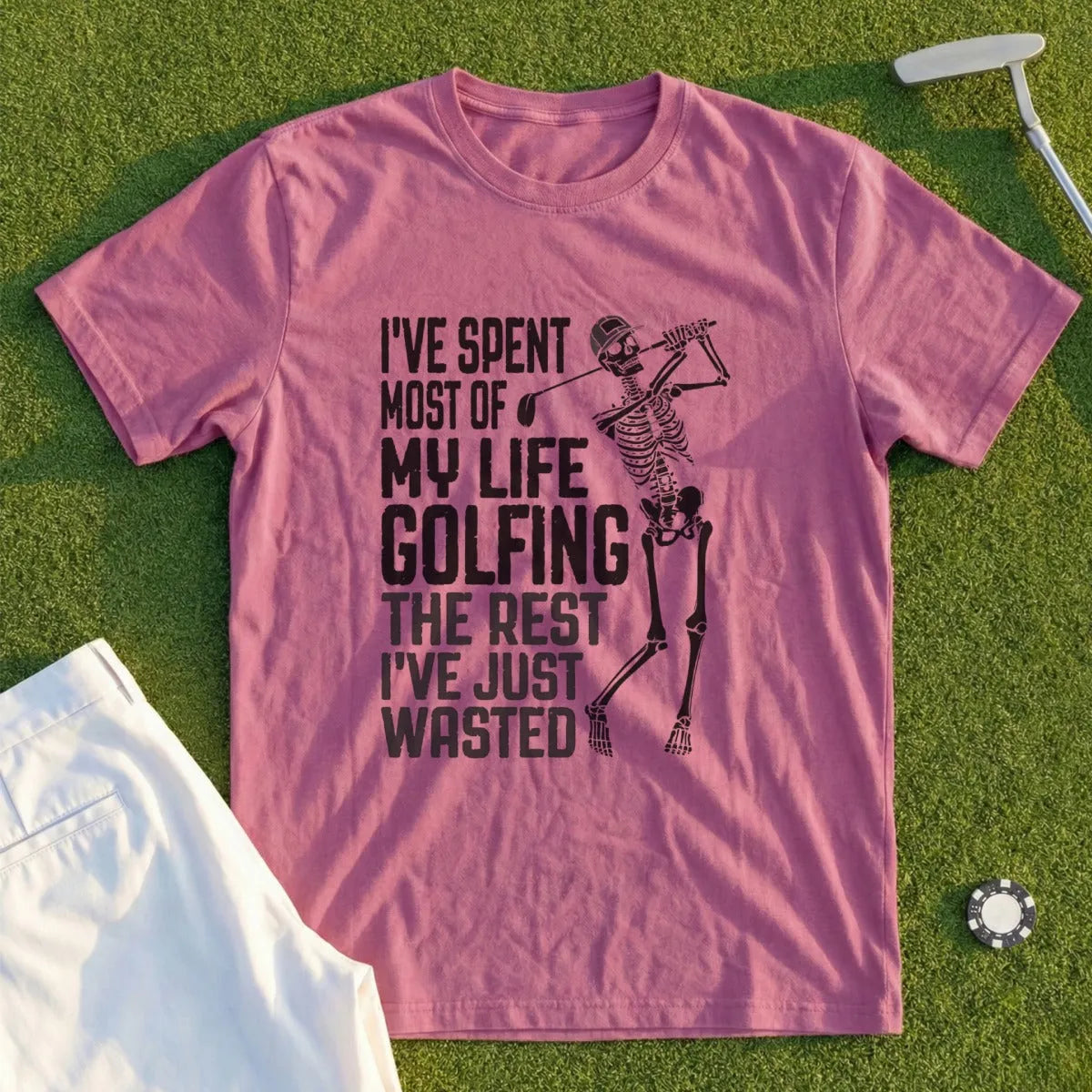 Pink t-shirt with skeleton golfer and text "I've spent most of my life golfing the rest I've just wasted".