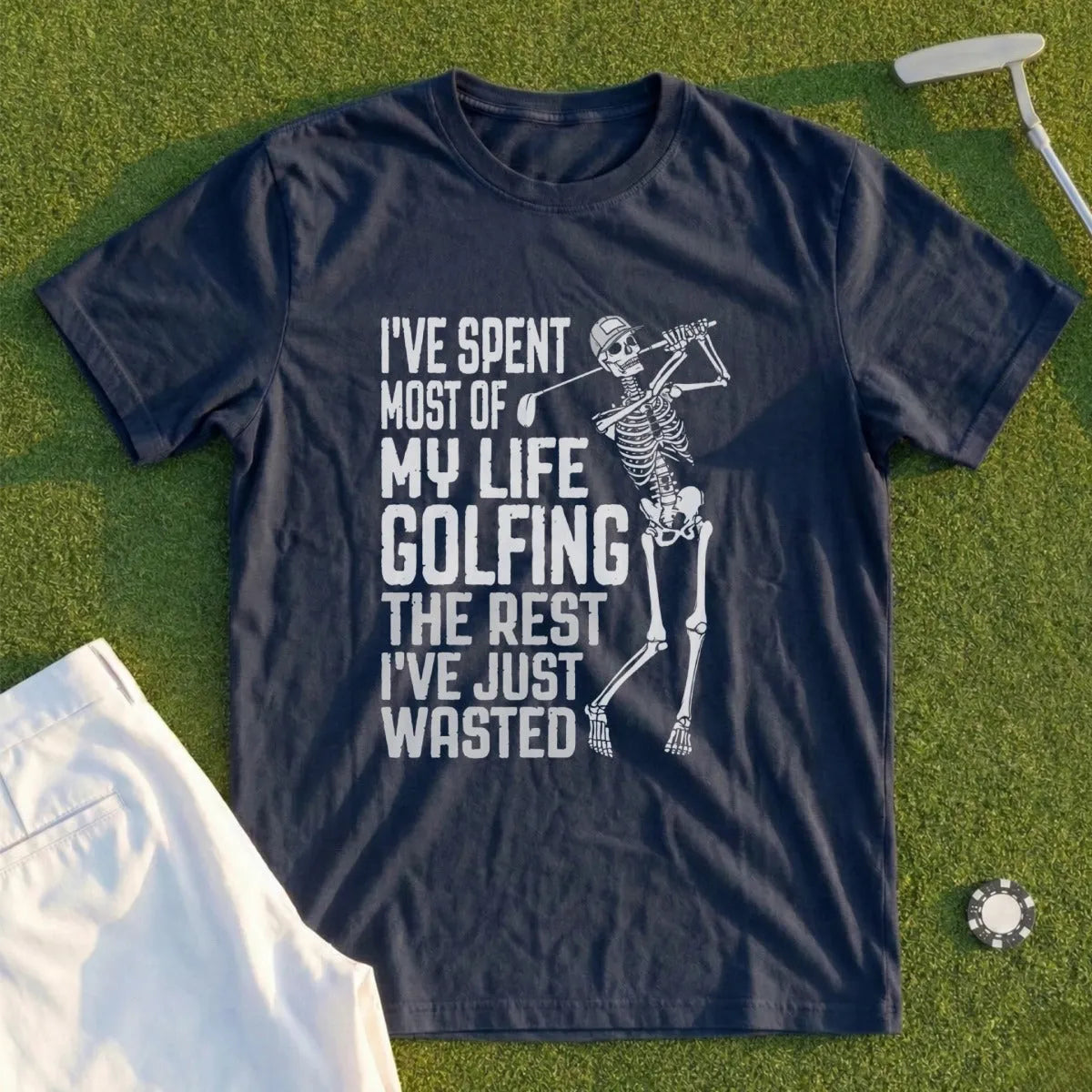 Dark blue t-shirt with skeleton golfing and text "I've spent most of my life golfing the rest I've just wasted."