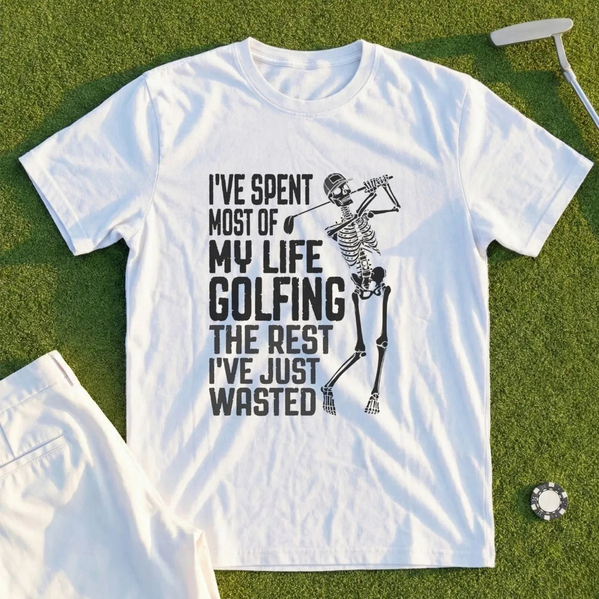 White t-shirt with skeleton golfer graphic and text "I've spent most of my life golfing the rest I've just wasted."