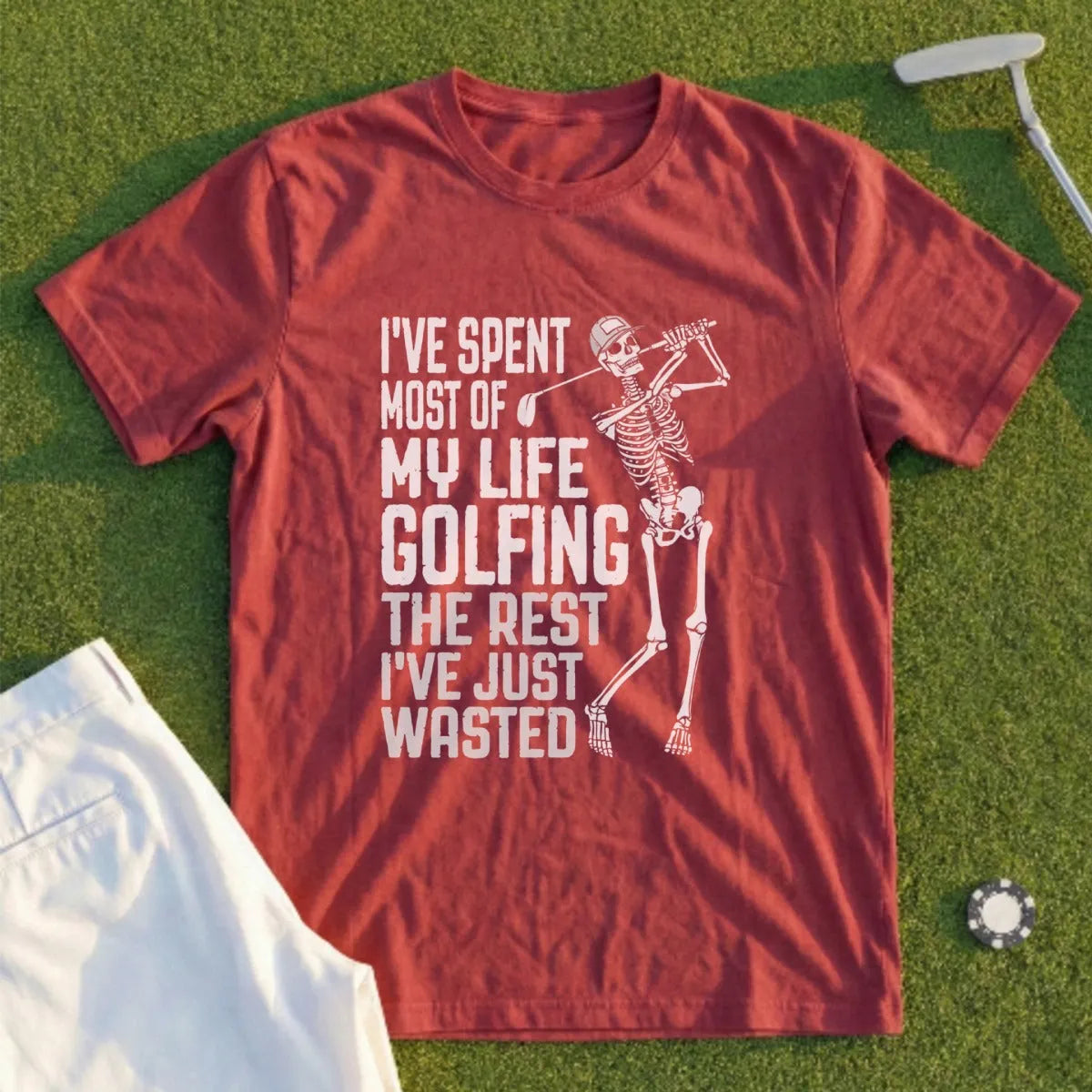 Red t-shirt with a skeleton golfing and the text "I've spent most of my life golfing, the rest I've just wasted."