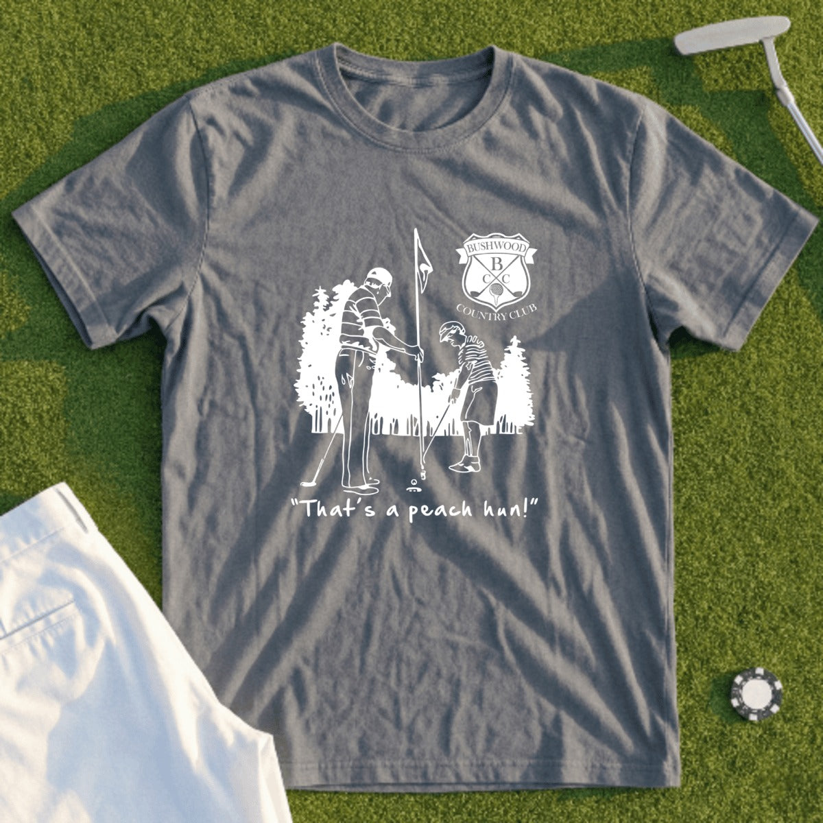 Gray t-shirt with a graphic of two golfers and text, "That's a peach hun!".