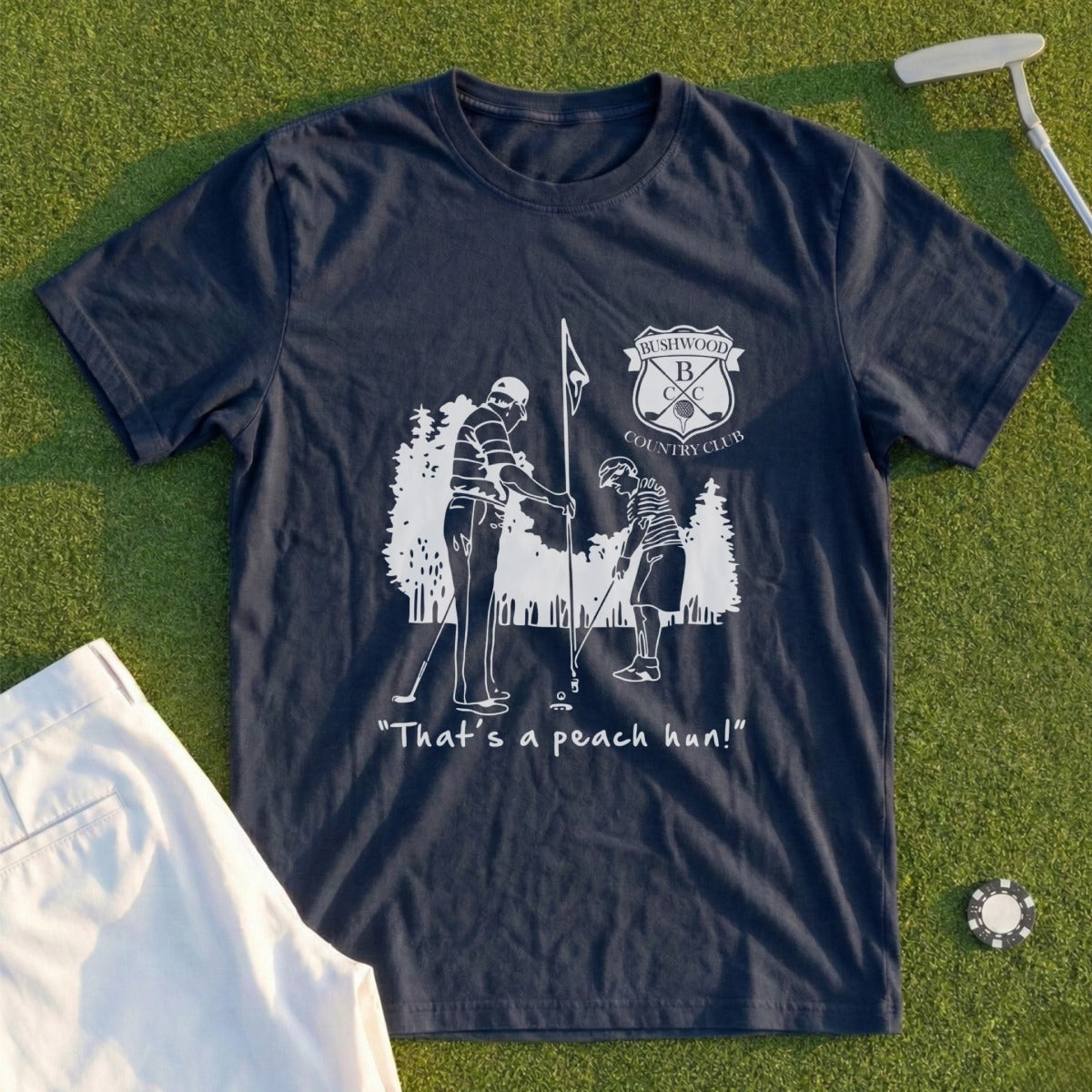 Navy t-shirt with cartoon golfers and "That's a peach hun!" quote.