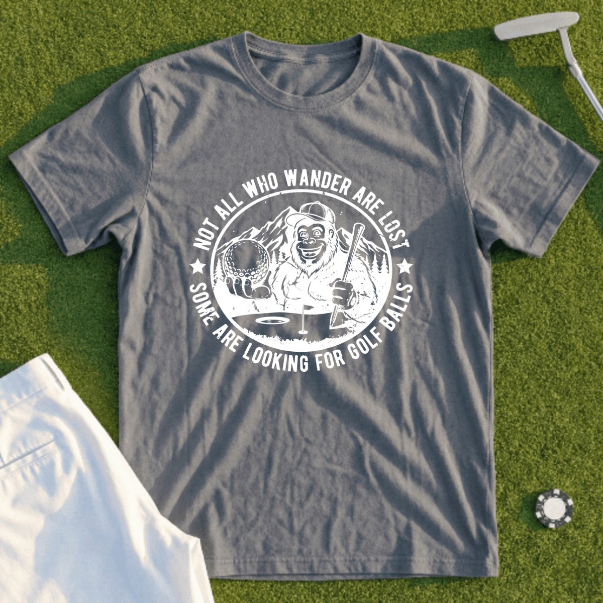 Graphic tee with Bigfoot holding a golf ball and the text "Some are looking for golf balls".