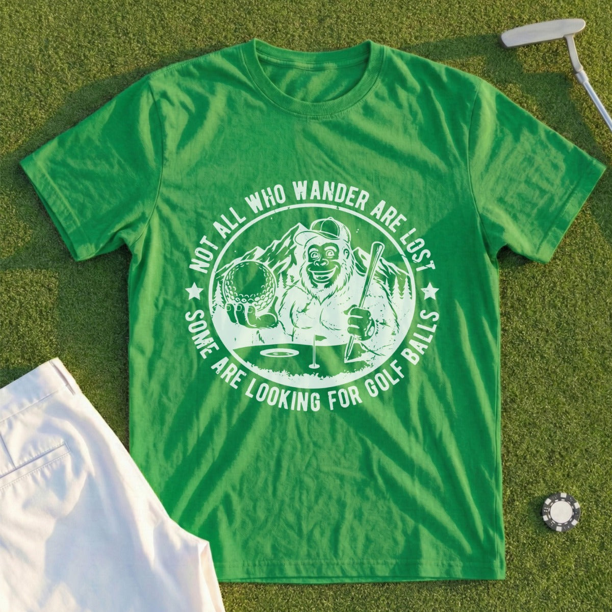 Green t-shirt with Bigfoot swinging a golf club and text "Not all who wander are lost".