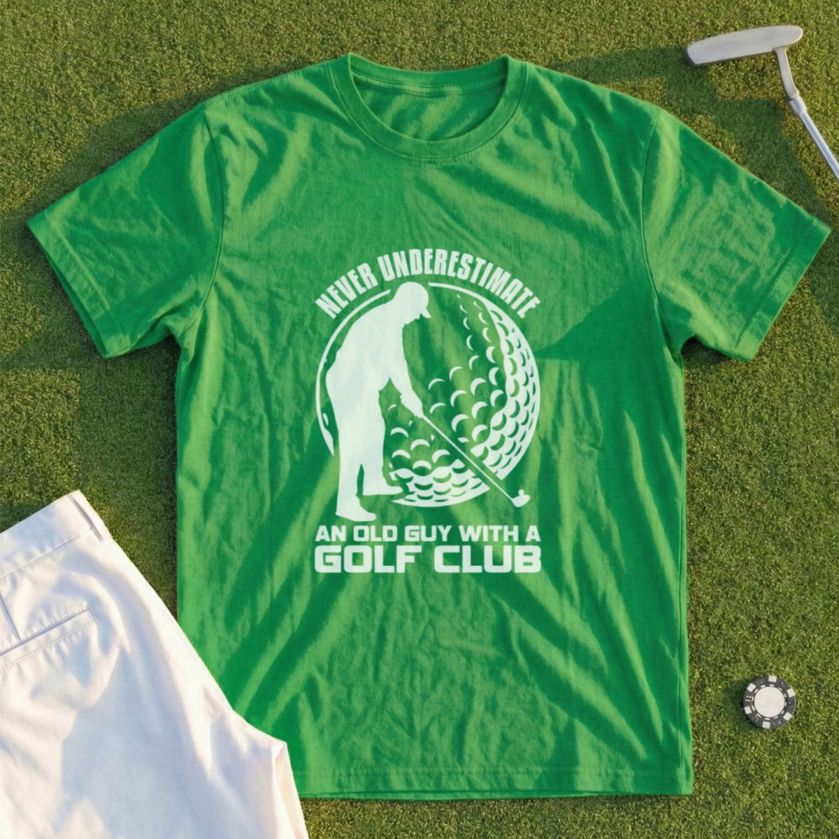 Green t-shirt with graphic of golfer and text "Never underestimate an old guy with a golf club."