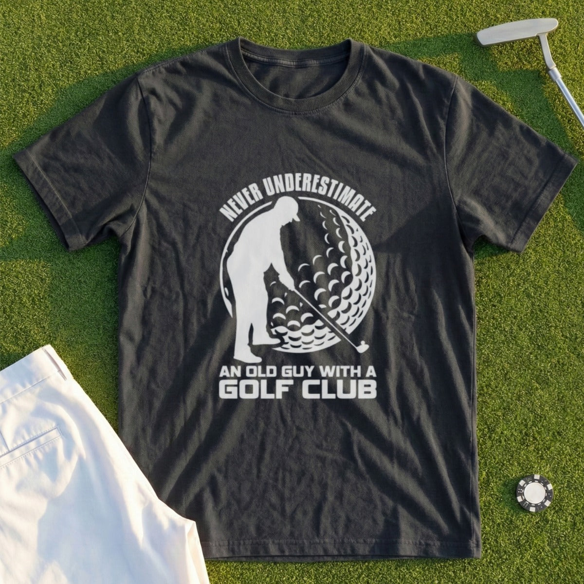 Dark t-shirt with graphic of golfer and text "Never underestimate an old guy with a golf club".