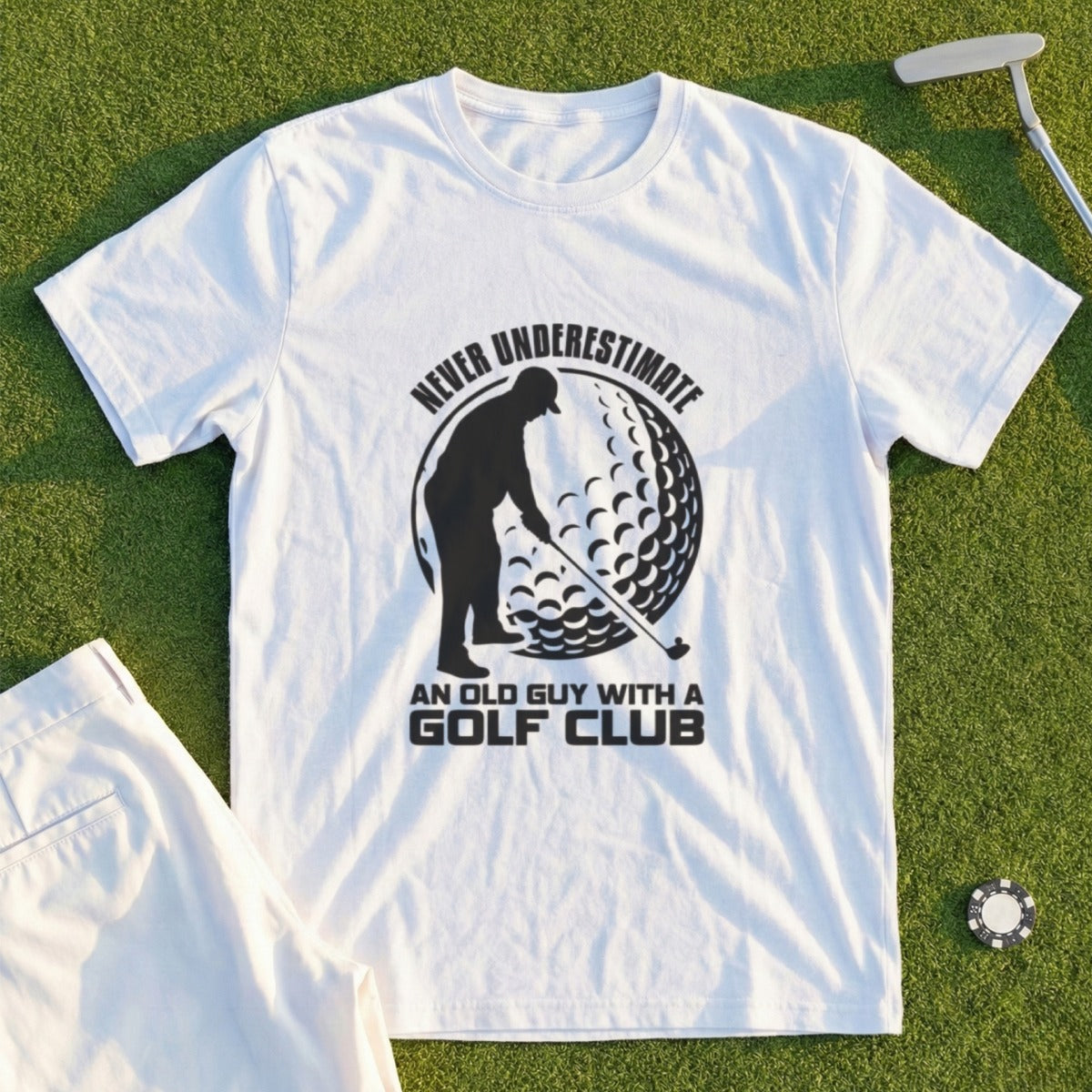 White t-shirt with graphic of golfer and text "Never underestimate an old guy with a golf club".