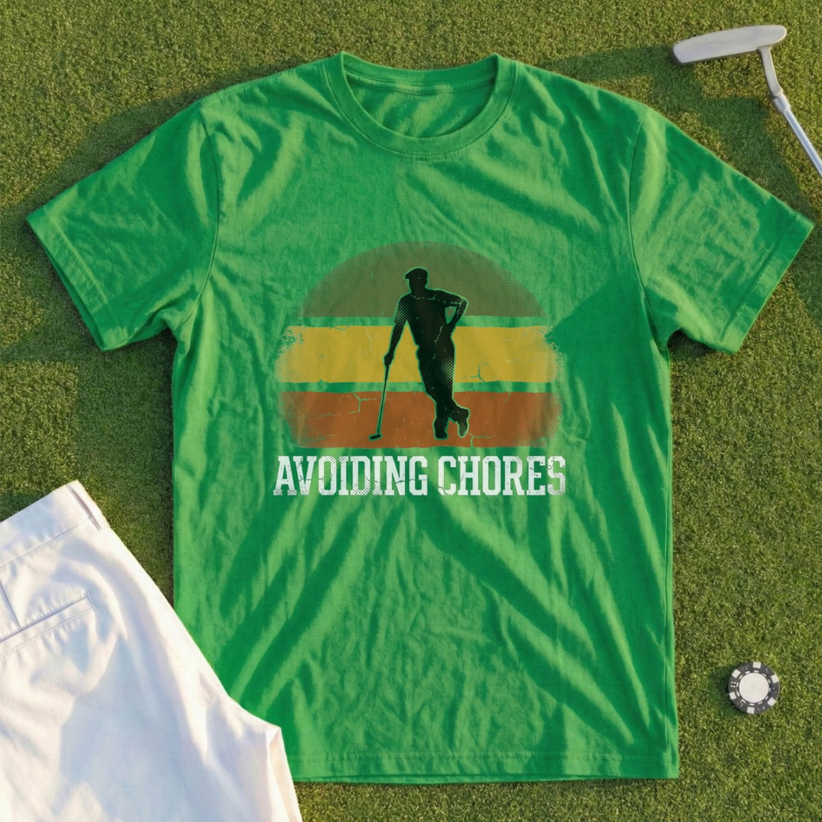 Green t-shirt with "AVOIDING CHORES" text and golfer silhouette.