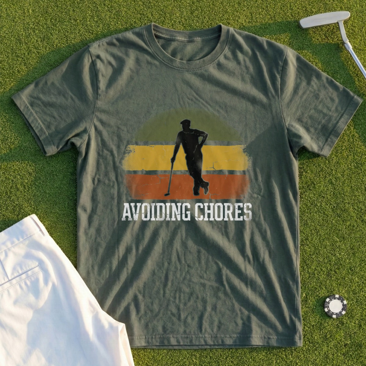 Green t-shirt with graphic of golfer and "Avoiding Chores" text.