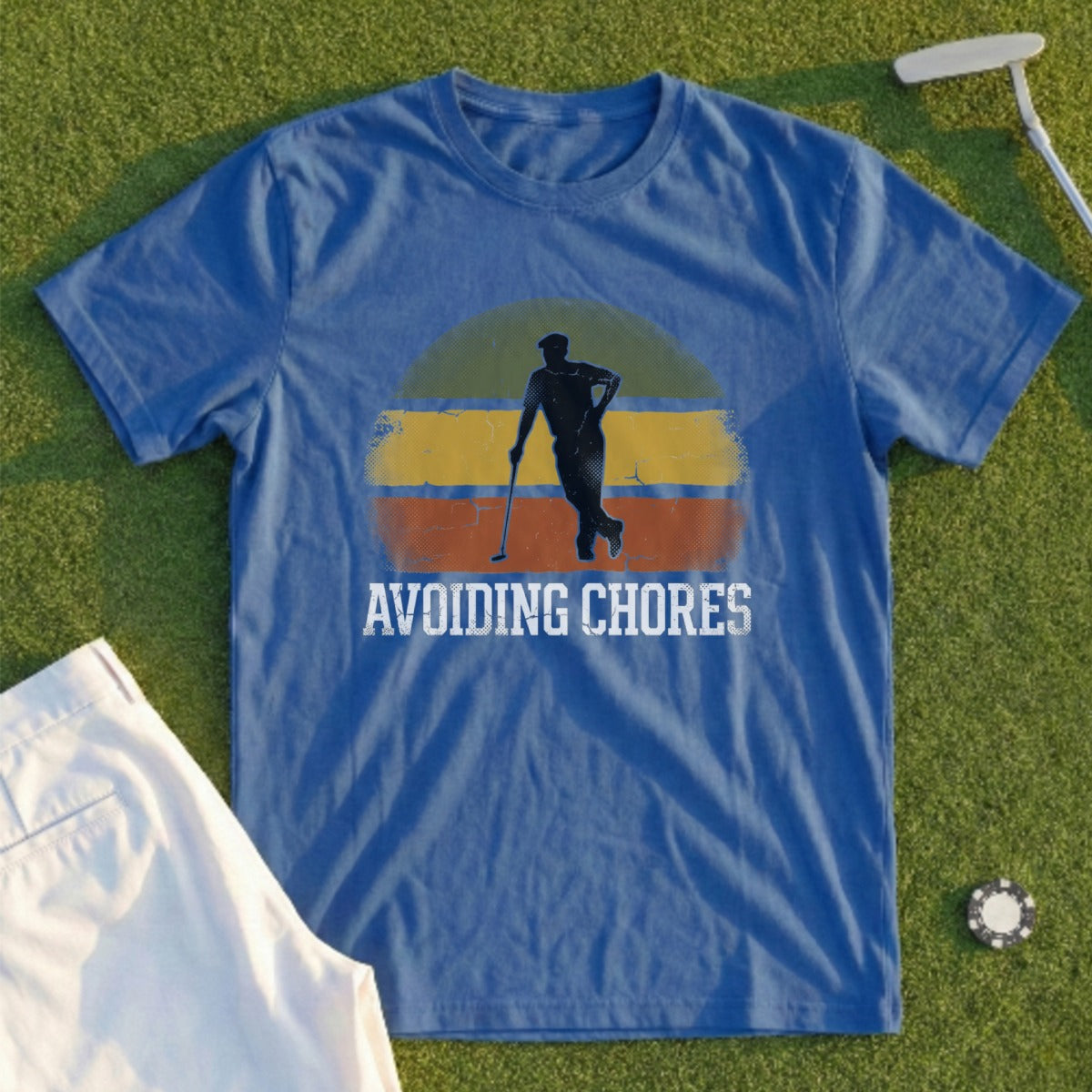 Blue t-shirt with graphic of golfer and text "AVOIDING CHORES"