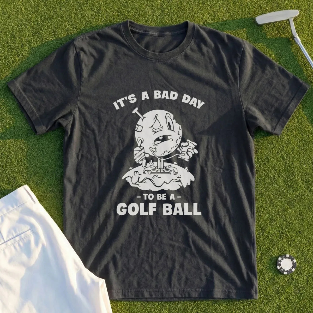 Dark t-shirt with graphic text "IT'S A BAD DAY TO BE A GOLF BALL".