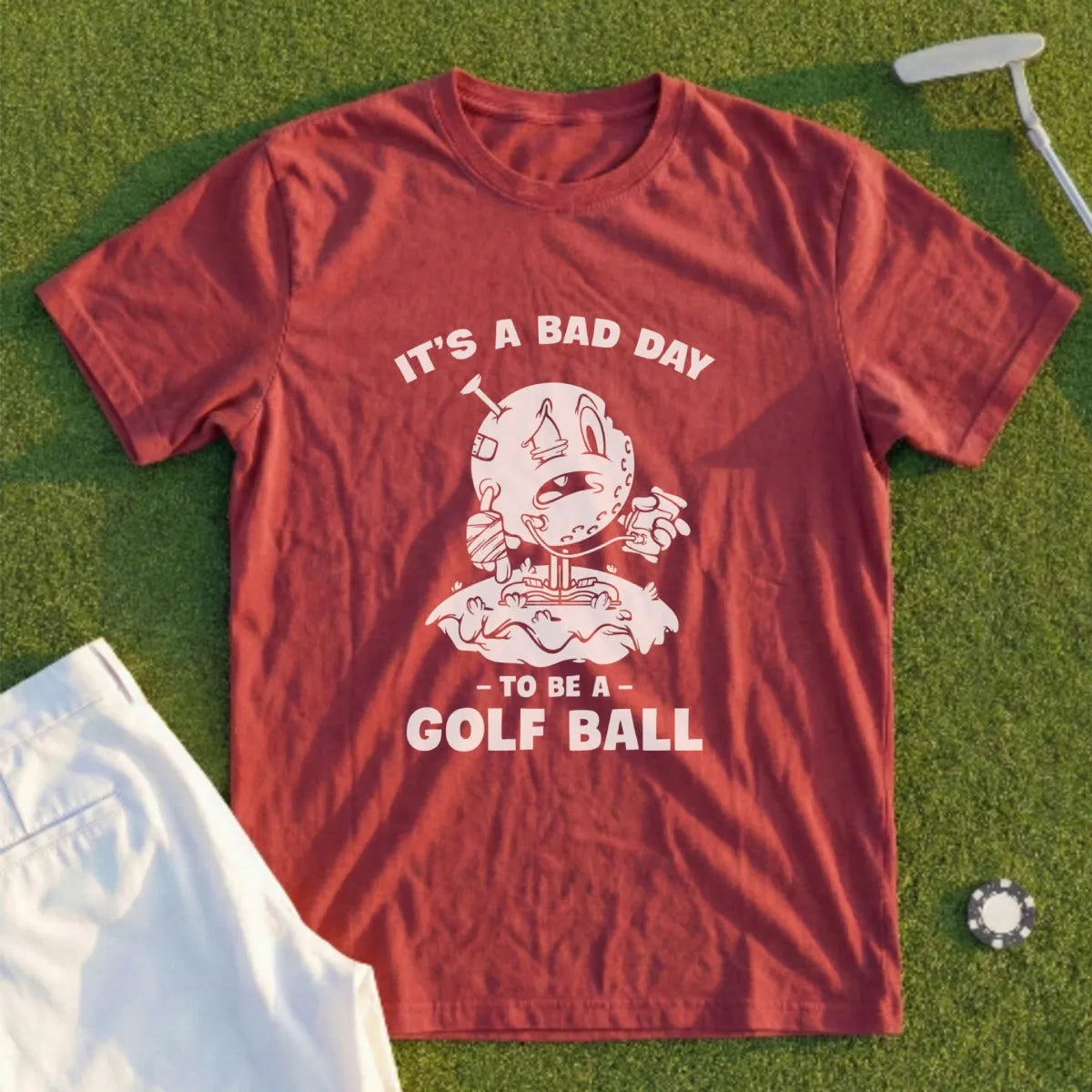 Red t-shirt with "IT'S A BAD DAY TO BE A GOLF BALL" text and cartoon.