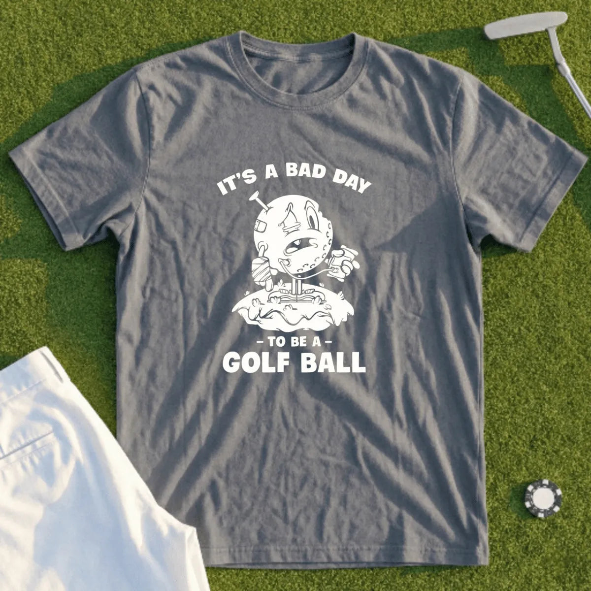 T-shirt with graphic of a sad golf ball and text "It's a bad day to be a golf ball".