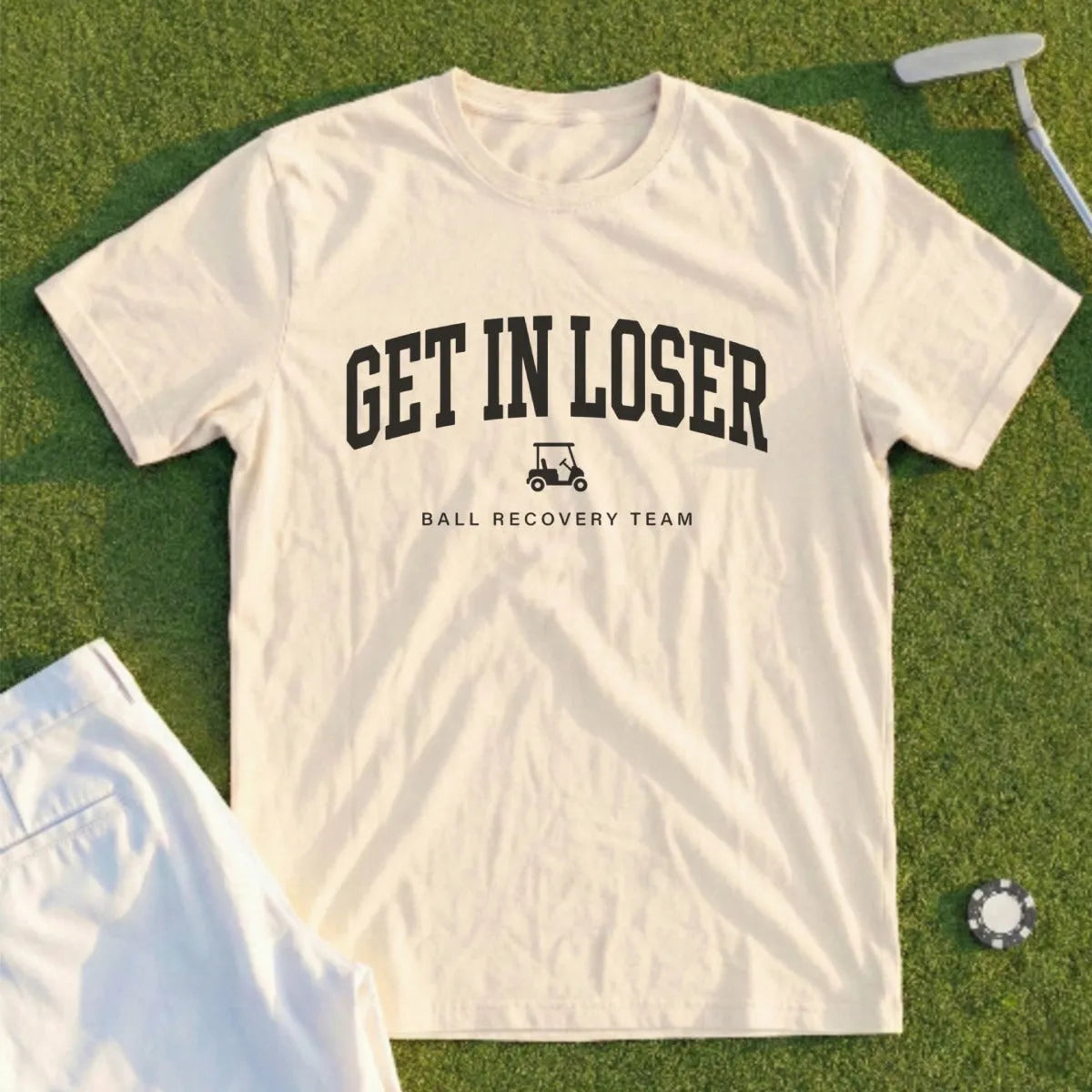 Cream t-shirt with "GET IN LOSER" and golf cart graphic.