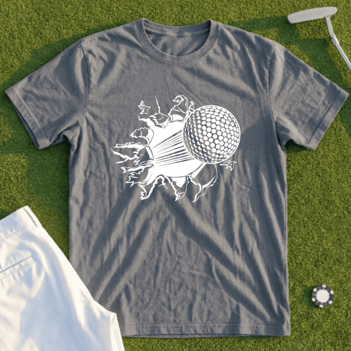 Grey t-shirt with a white graphic of a golf ball bursting through a torn surface.