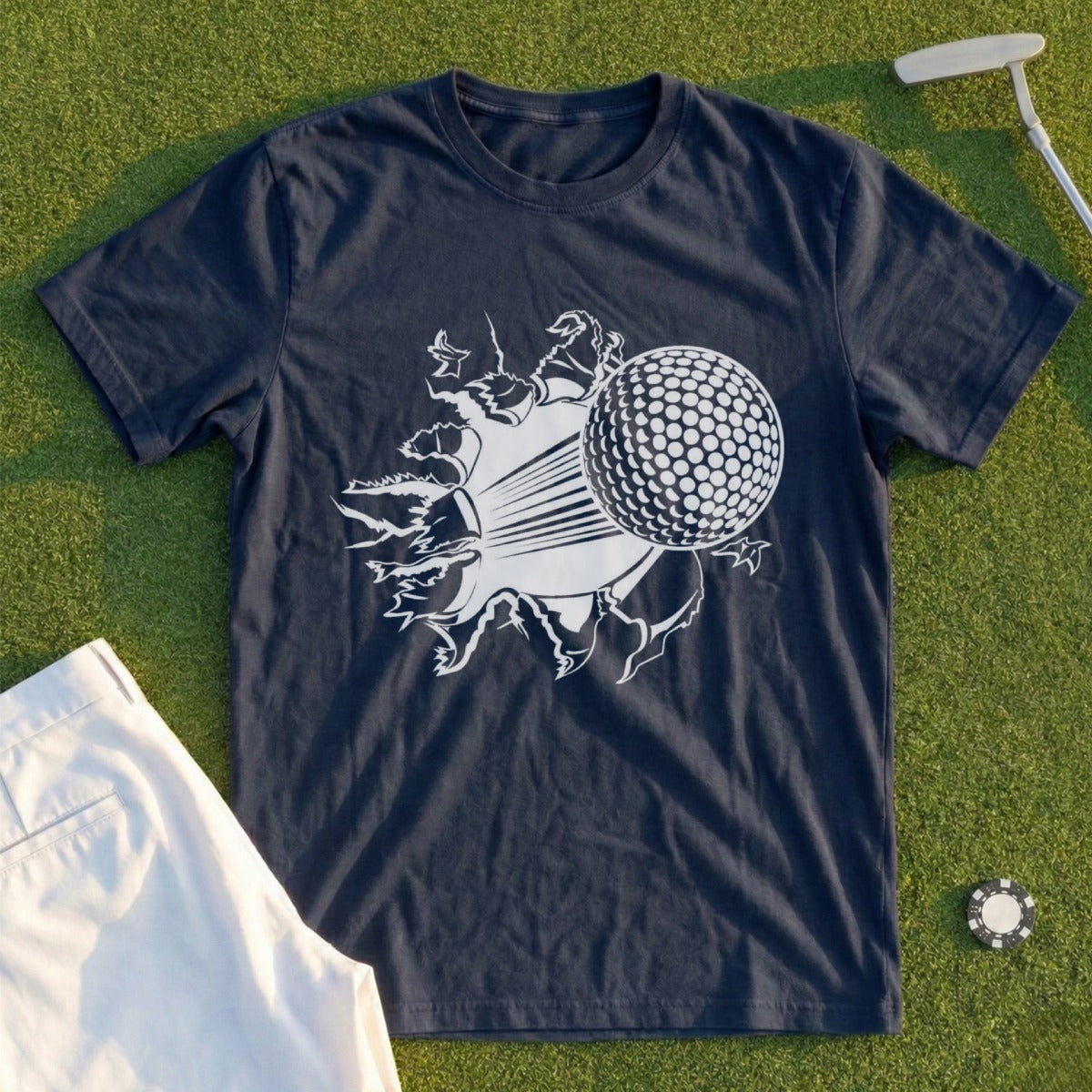 Dark blue t-shirt with a white graphic of a golf ball breaking through a surface.