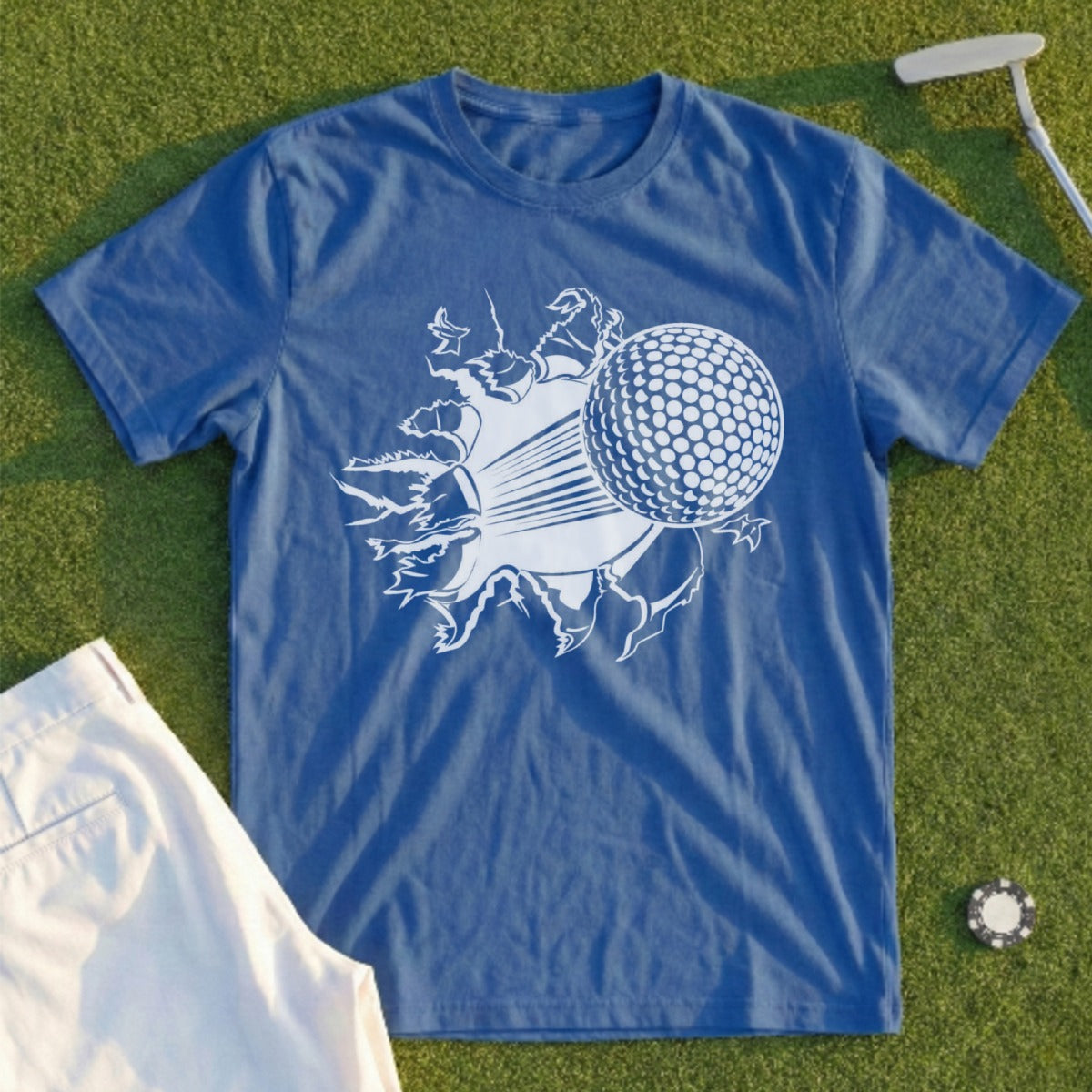 Blue t-shirt with a white golf ball bursting through the fabric.