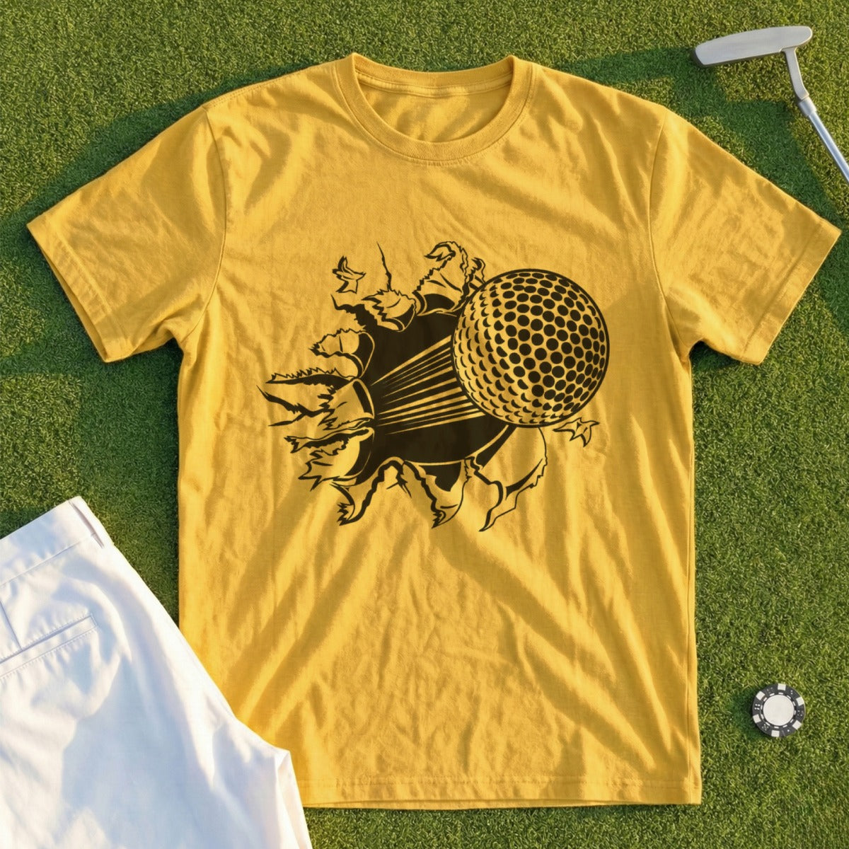 Yellow t-shirt with a graphic of a golf ball breaking through a torn surface.