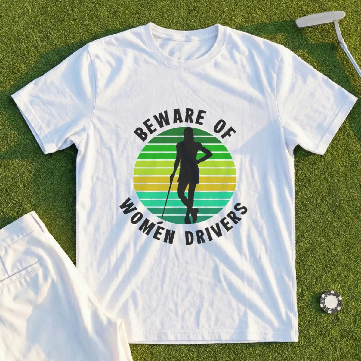 White t-shirt with green and yellow striped circle graphic and "Beware of Women Drivers" text.