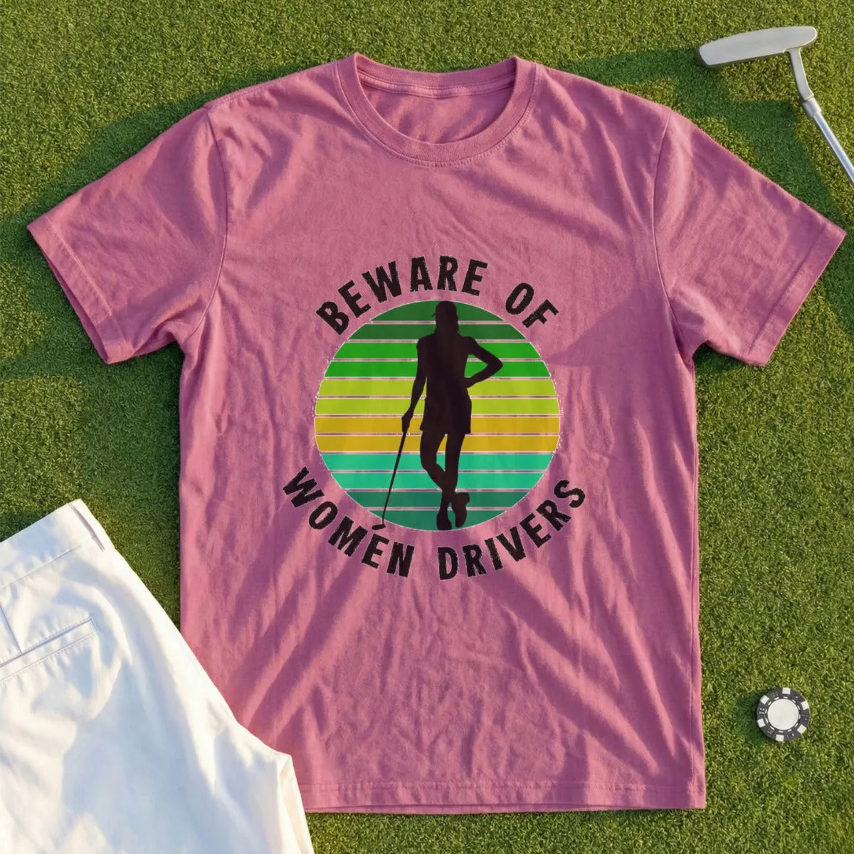 Pink t-shirt with "Beware of Women Drivers" text and golfer silhouette.
