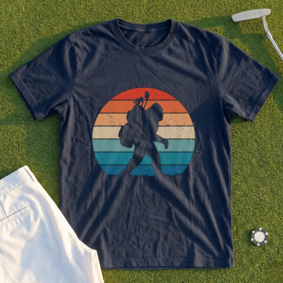 Silhouette of Bigfoot carrying a golf bag against a sunset.