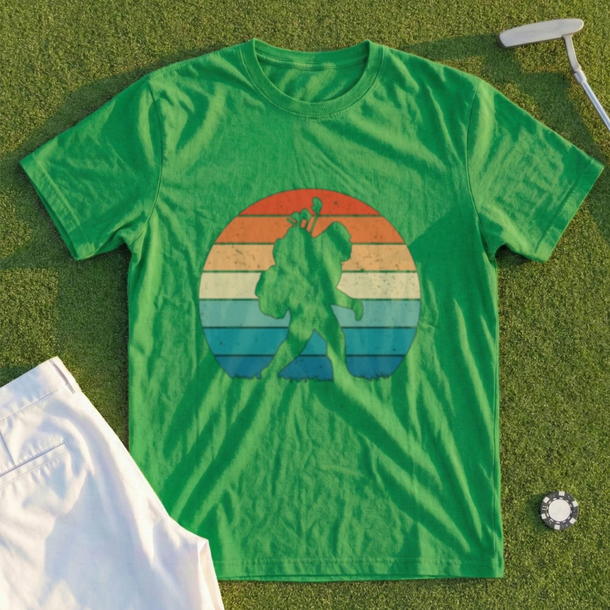 Green t-shirt with Bigfoot silhouette against a retro sunset graphic.