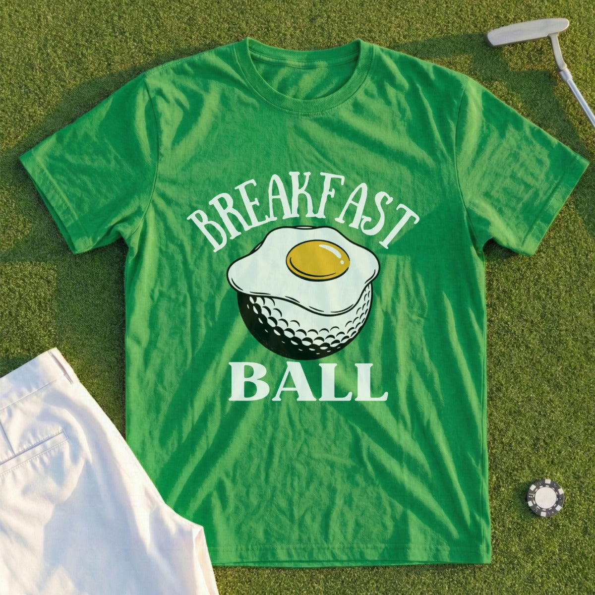 Green t-shirt with "BREAKFAST BALL" and fried egg on golf ball graphic.