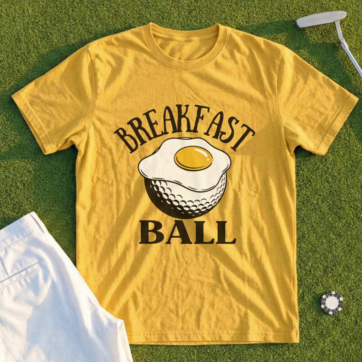 Yellow t-shirt with a fried egg on a golf ball and "Breakfast Ball" text.
