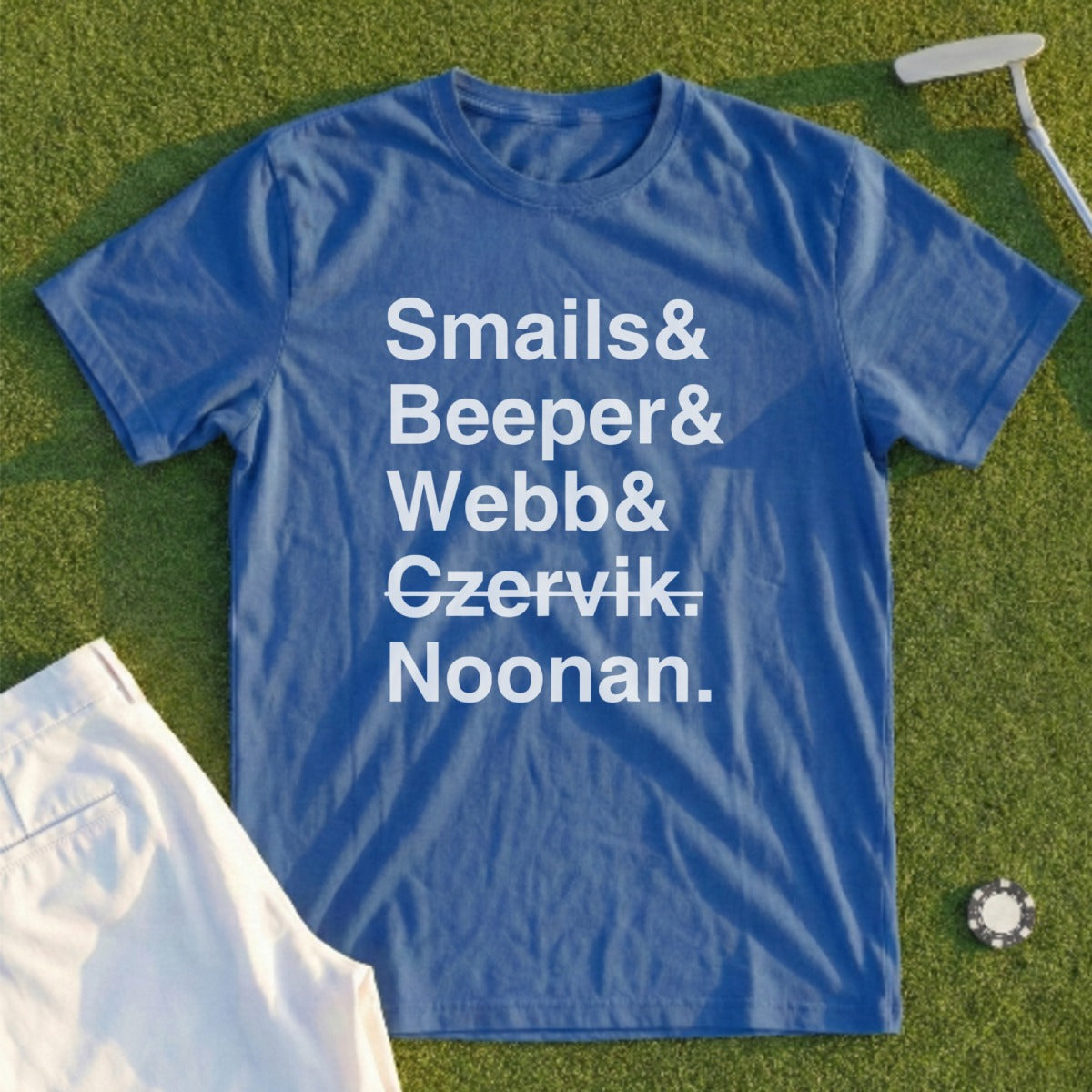 Blue t-shirt with names "Smails & Beeber & Czervik. Noonan." on a golf course.