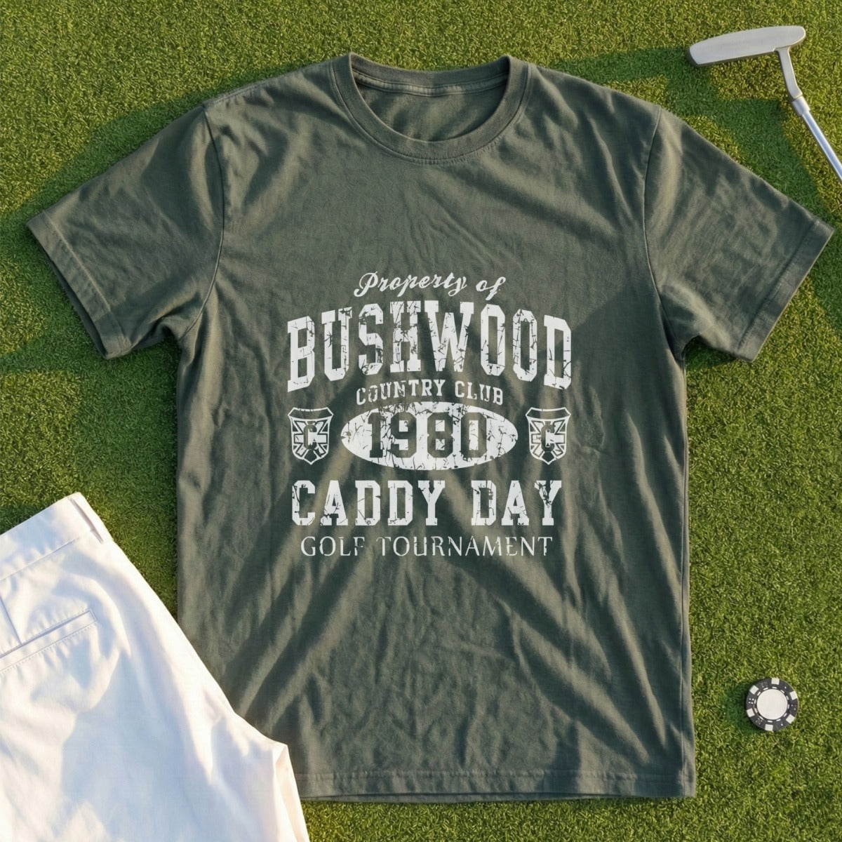 Green t-shirt with "Property of Bushwood Country Club 1980 Caddy Day Golf Tournament" text.