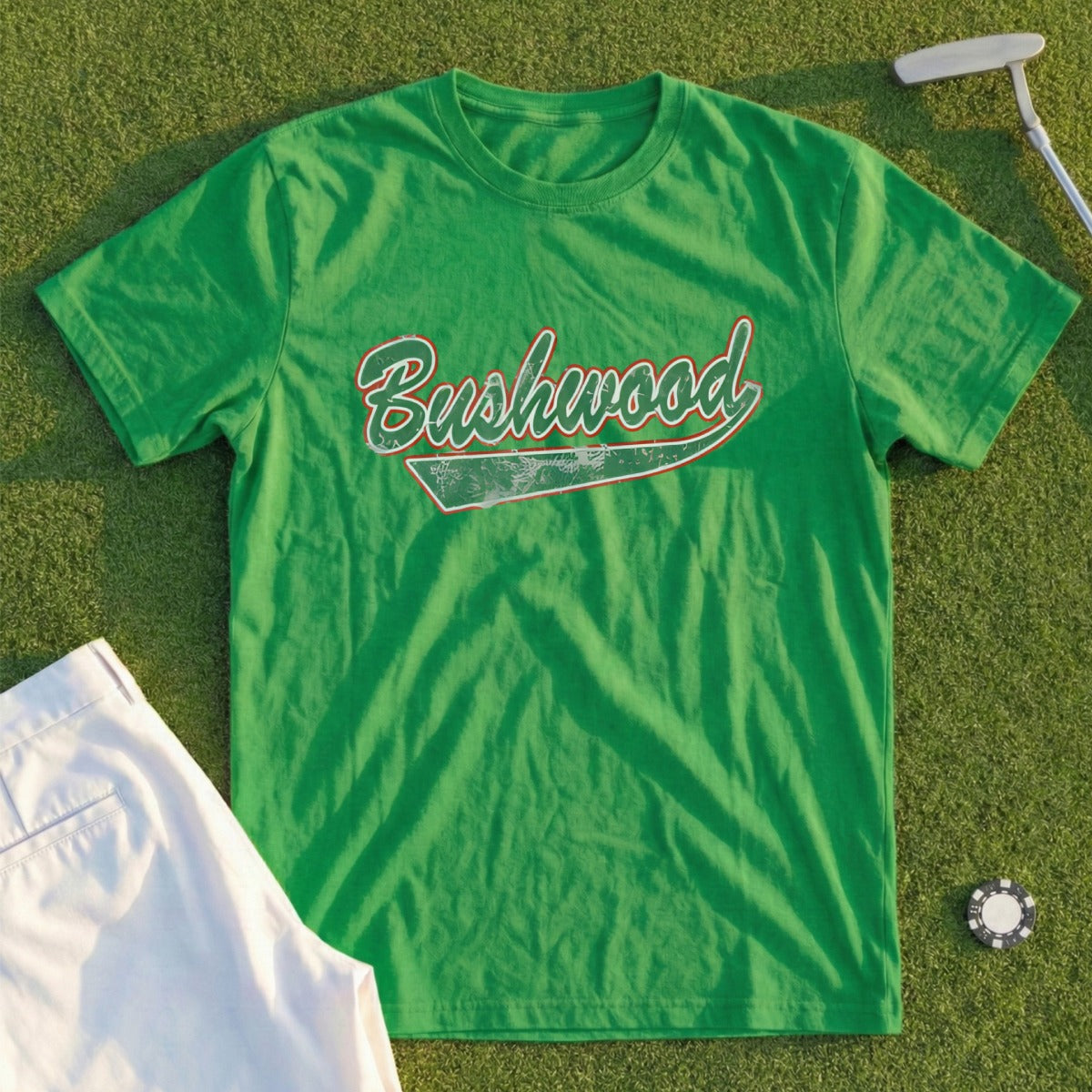 Green t-shirt with "Bushwood" in red and white text, with golf attire.