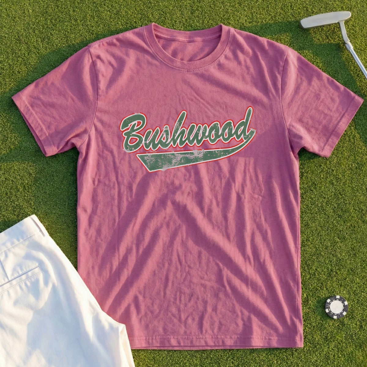 Rose t-shirt with "Bushwood" text, golf course background.
