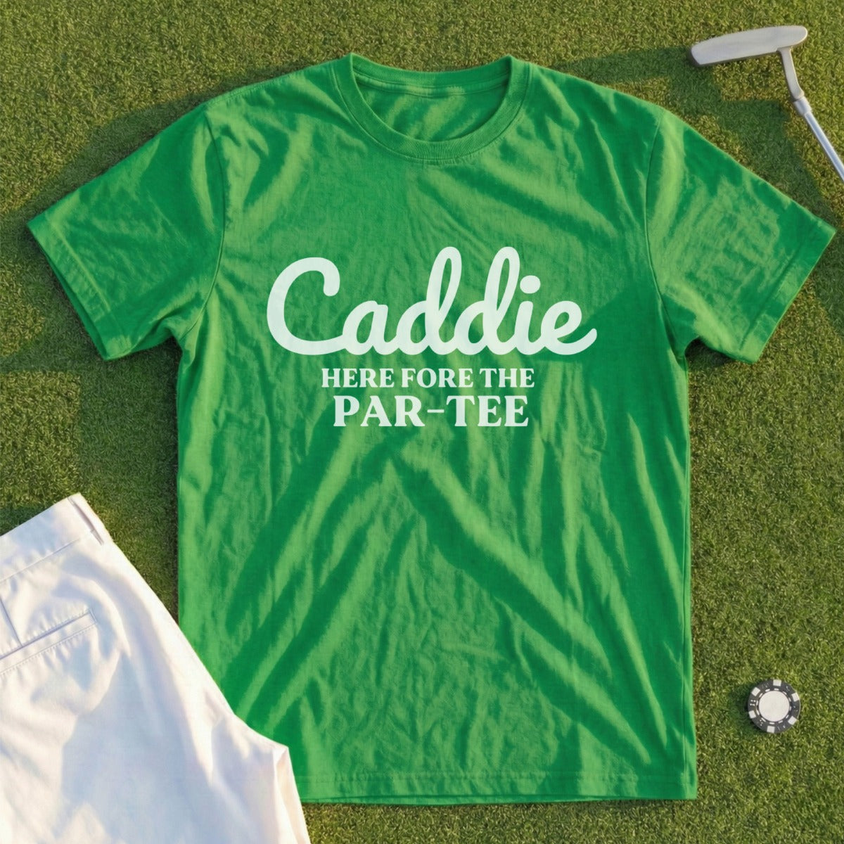 Green t-shirt with "Caddie HERE fore THE PAR-TEE" text, golf attire.