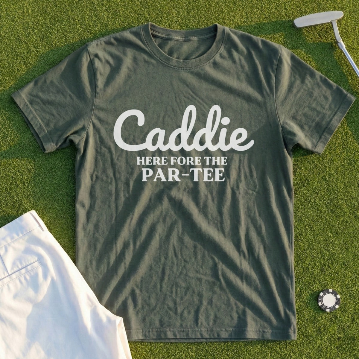 Green t-shirt with "Caddie HERE fore the PAR-TEE" in white text.