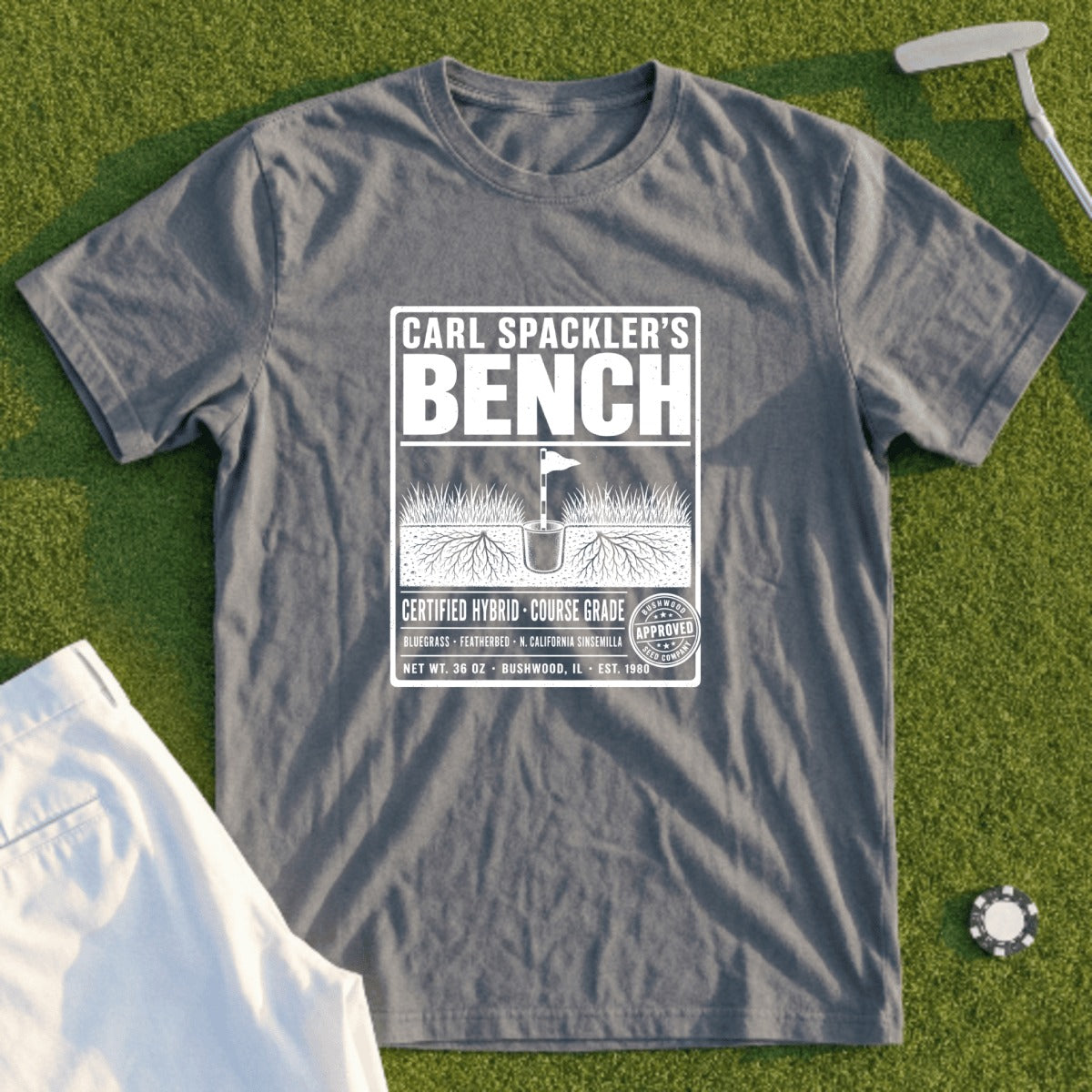 Grey t-shirt with "Carl Spackler's Bench" and a golf course seed bag design.