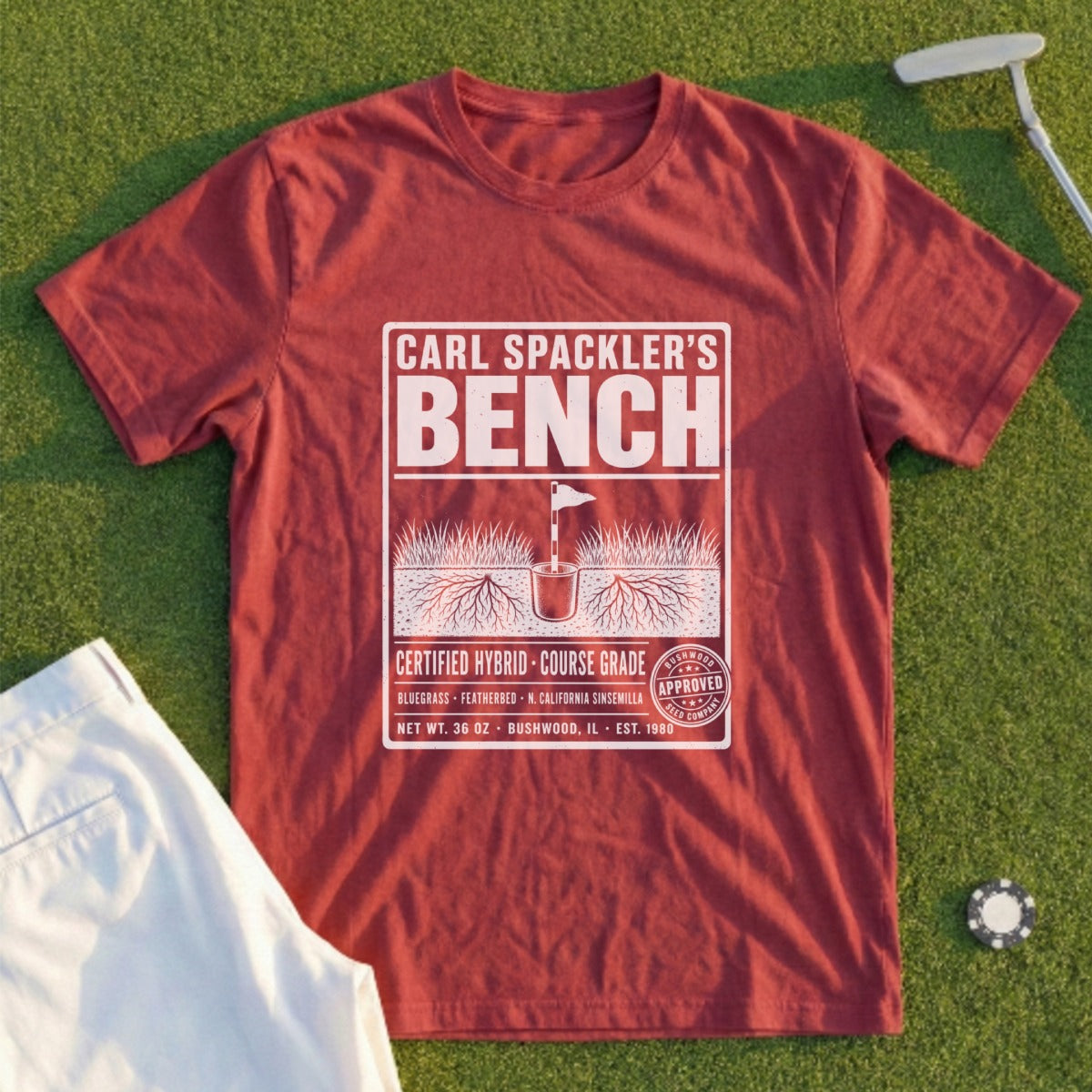 Red t-shirt with "Carl Spackler's Bench" logo featuring golf theme and text.