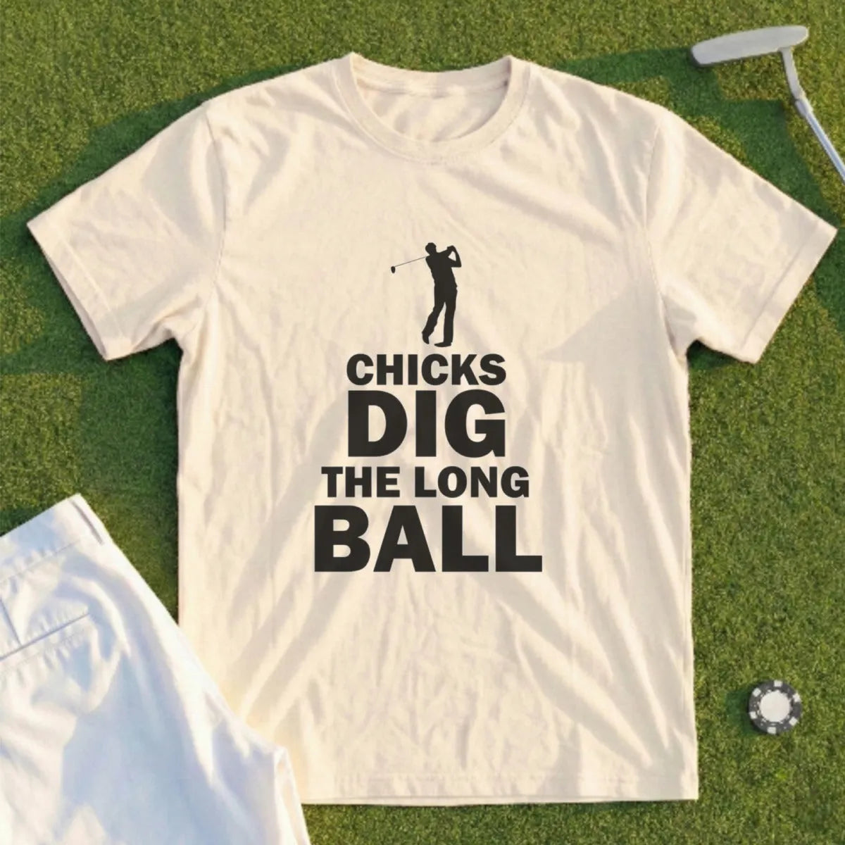 Cream t-shirt with black text "Chicks Dig The Long Ball" and a golfer silhouette.