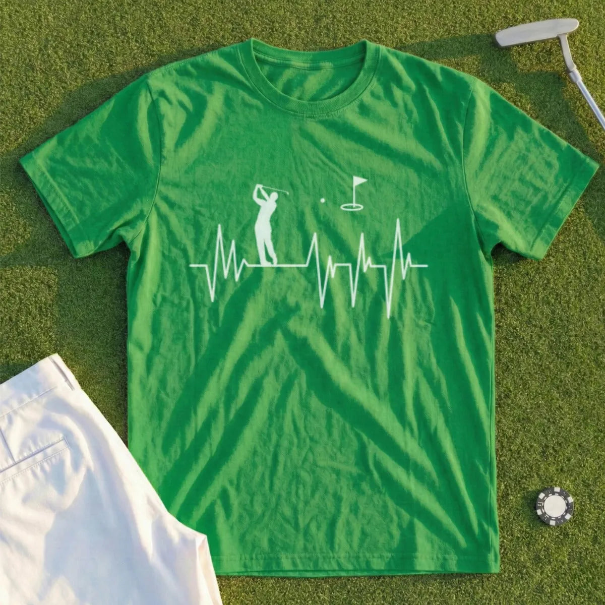Green t-shirt with golf heartbeat design and white shorts.