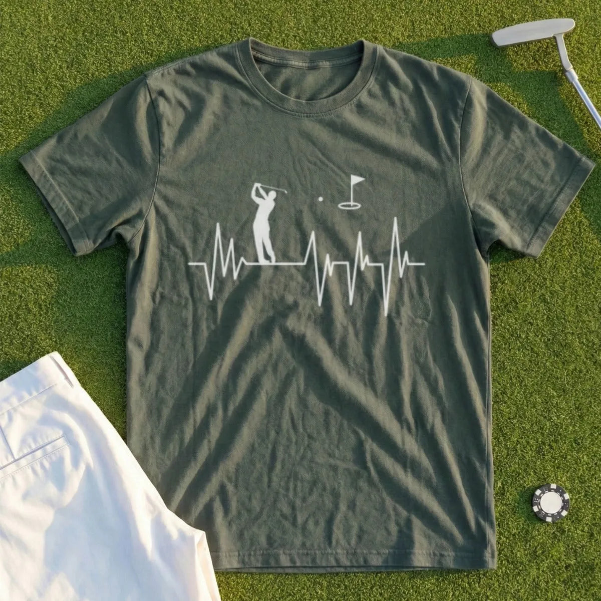 Olive green t-shirt with golf heartbeat graphic and golf accessories.
