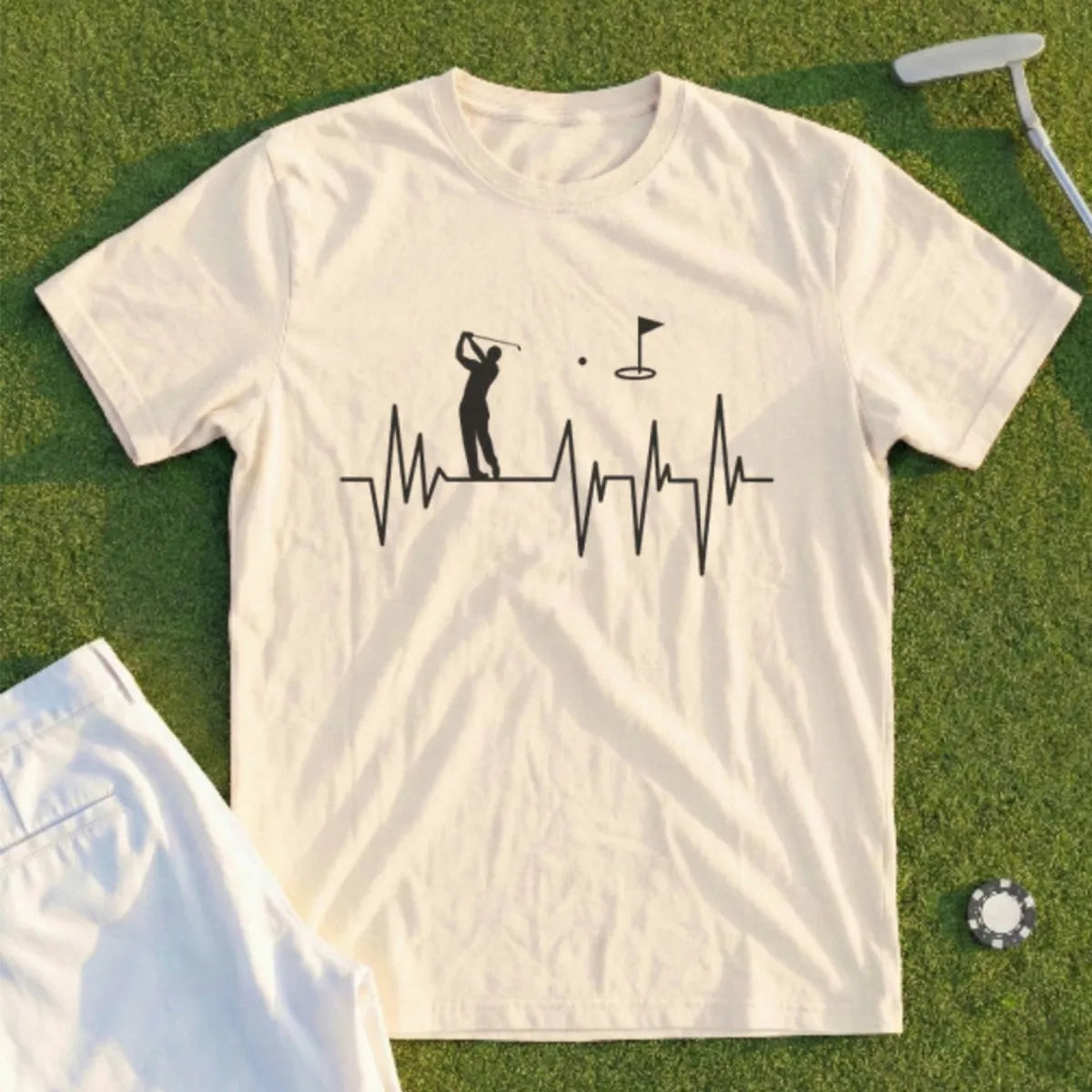 Cream t-shirt with golfer silhouette and heartbeat graphic.
