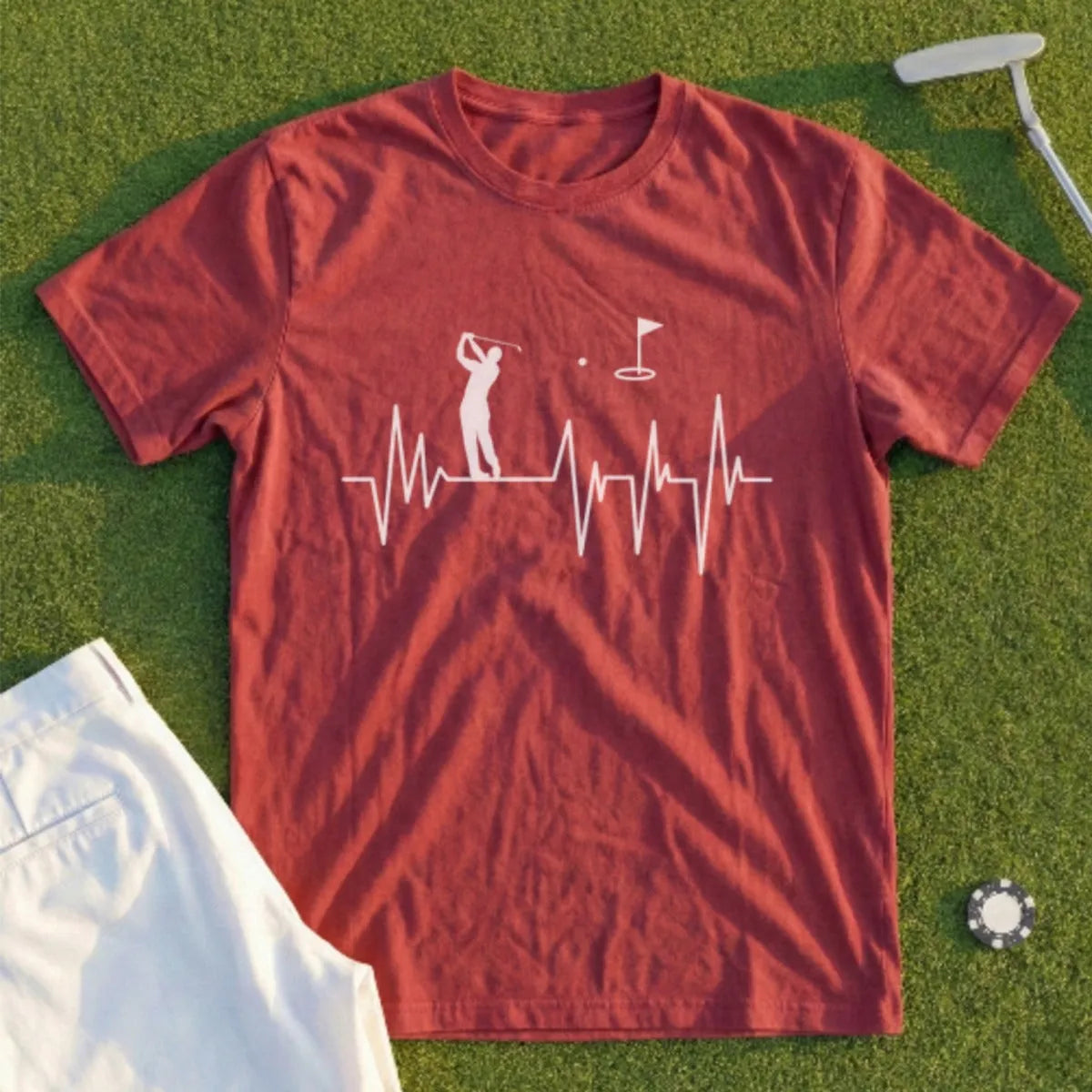Red t-shirt with golf heartbeat graphic, white pants, and golf ball.