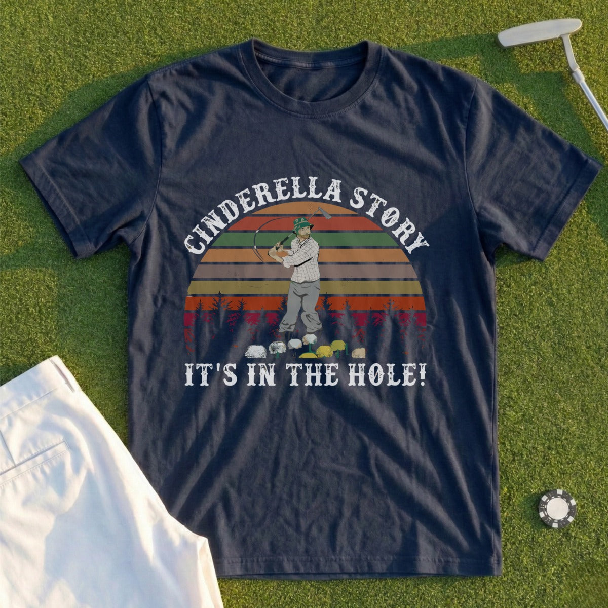 Navy t-shirt with "Cinderella Story IT'S IN THE HOLE!" text and cartoon golf imagery.