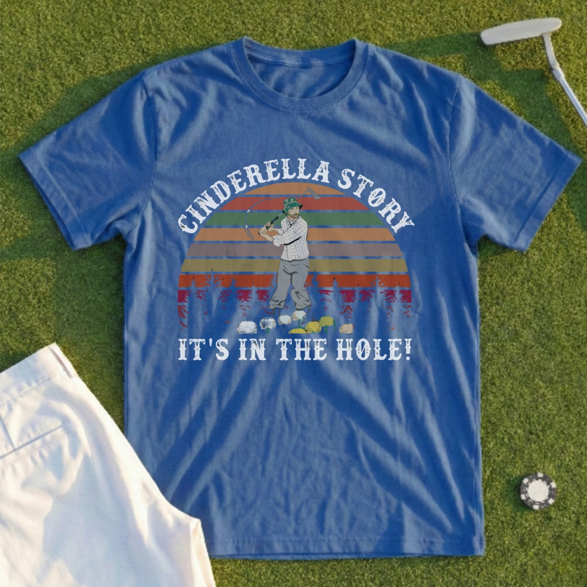 Blue t-shirt with "Cinderella Story it's in the hole!" text and golfer graphic.